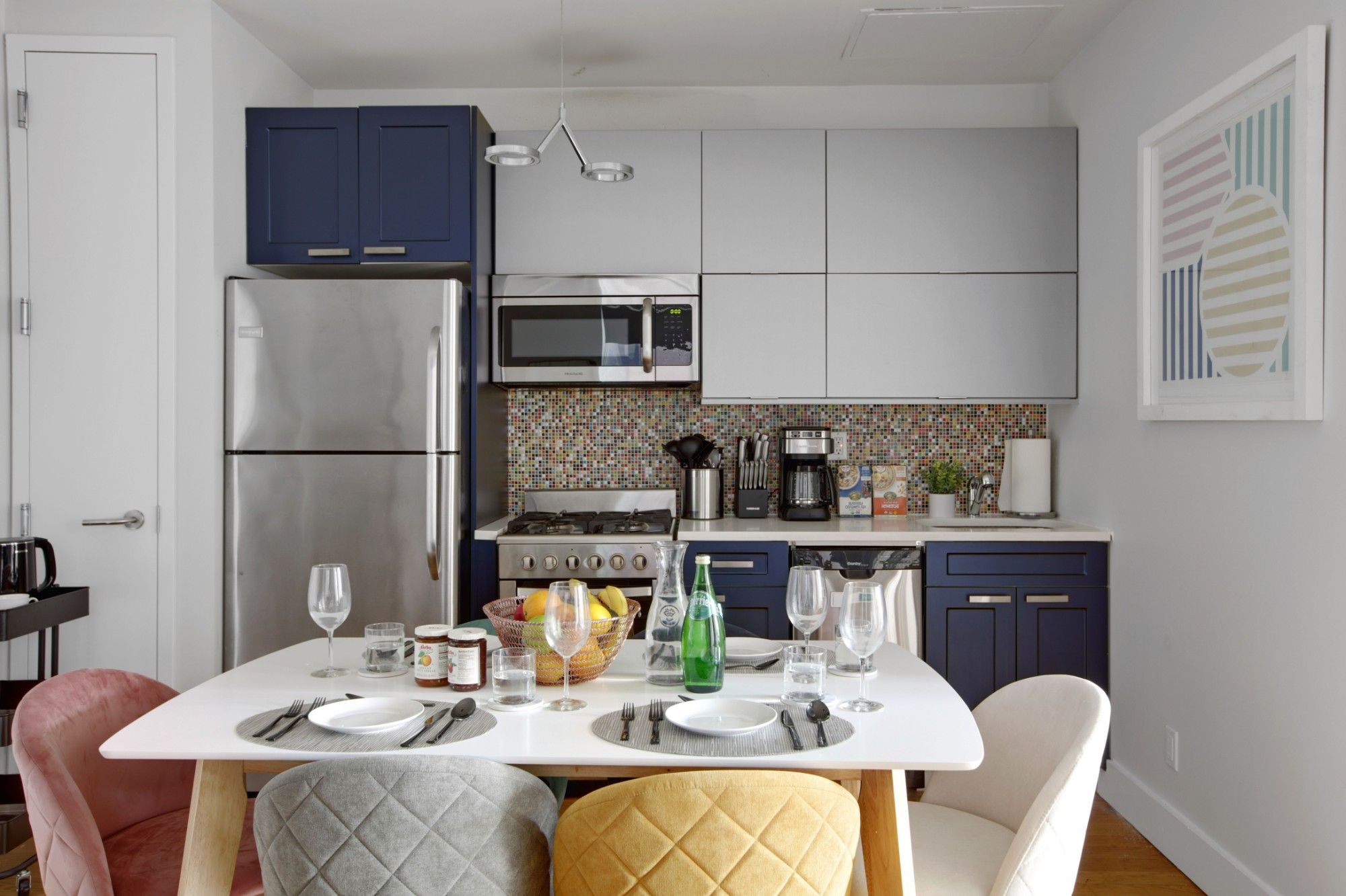 A fully equipped kitchen and dining table in a Roomrs apartment